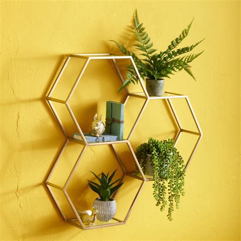 This honeycomb unit graces the studio wall of artist d. Gold and Glass Honeycomb Wall Shelf | World Market ...