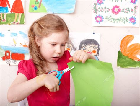 Child With Scissors Cut Paper At Home — Stock Photo © Poznyakov 6725673