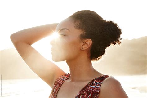Profile Of Mixed Race Woman Backlit By The Sun At The Beach By