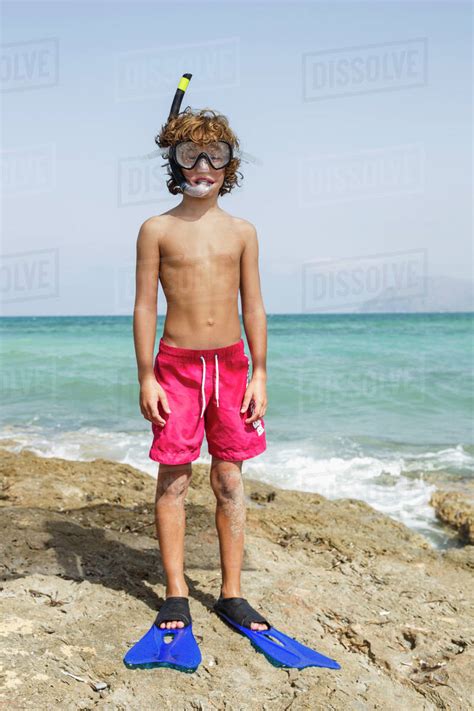 Spain Boy With Diving Equipment On Beach Stock Photo Dissolve