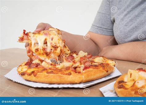 hungry overweight woman holding pizza and happy to eat pizza concept of binge eating disorder