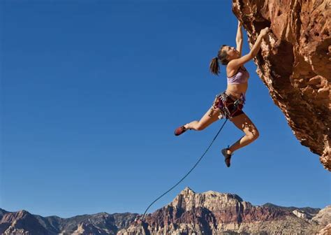 Female Rock Climber Clinging To A Cliff Stock Image Everypixel