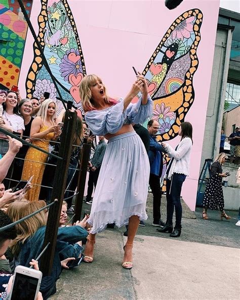 Taylor Swift In Front Of Her Custom Made Mural Of A Butterfly Wings In
