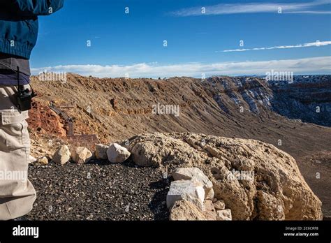 A Tour Guide Leads An Interpretive Walk Along The Rim Of The Meteor