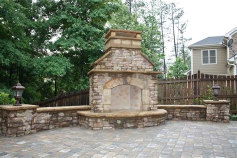 Outdoor Stacked Stone Fireplace With Seating Wall And
