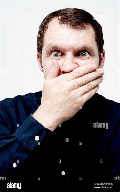 Middle Aged Scared Man Covering His Mouth Stock Photo Alamy