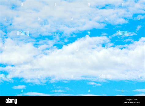 Puffy Clouds In A Blue Sky Stock Photo Alamy