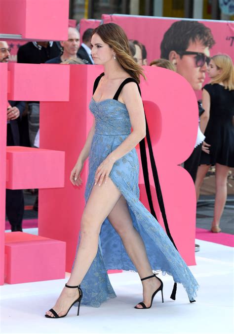 Lily James Squeezes Ample Assets Into Daring Thigh High Slit Dress
