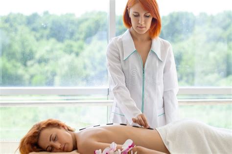 Young Woman Getting Hot Stone Massage In Spa Salon Stock Image Image