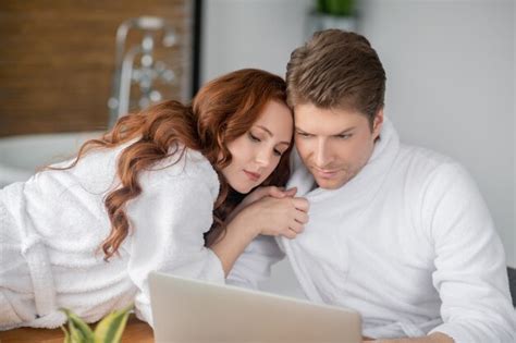 Premium Photo Tenderness Ginger Woman In A White Bathrobe And Her Husband Looking Happy And