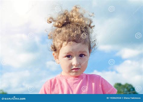 Portrait Of A Beautiful Little Surprised Girl Confused Child Outdoors