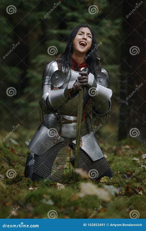 A Beautiful Warrior Girl With A Sword Wearing Chainmail And Armor