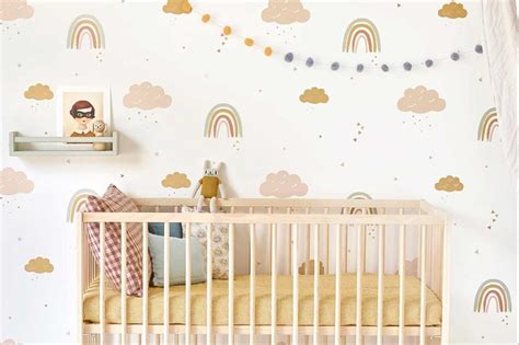 Yellow and charcoal grey moose themed baby gender neutral jungle nursery with mustard yellow canopy, oval crib and giant giraffe plush and banana leaf palm wallpaper. 60 adorable gender-neutral nursery ideas | loveproperty.com