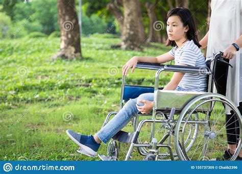 Disabled Daughter In Wheelchair Feeling Sadasian Little