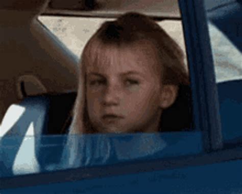 Serious Little Girl Riding Car Flipping Off 