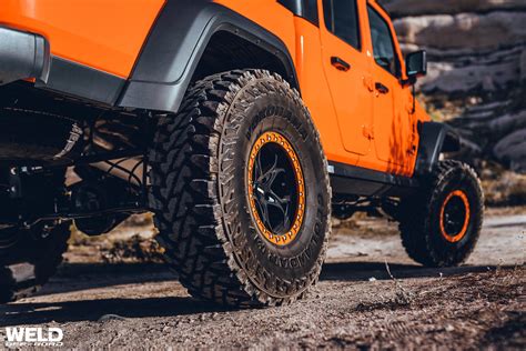 Orange Gladiator Jeep Modren Ledge Offroad Weld Wheels