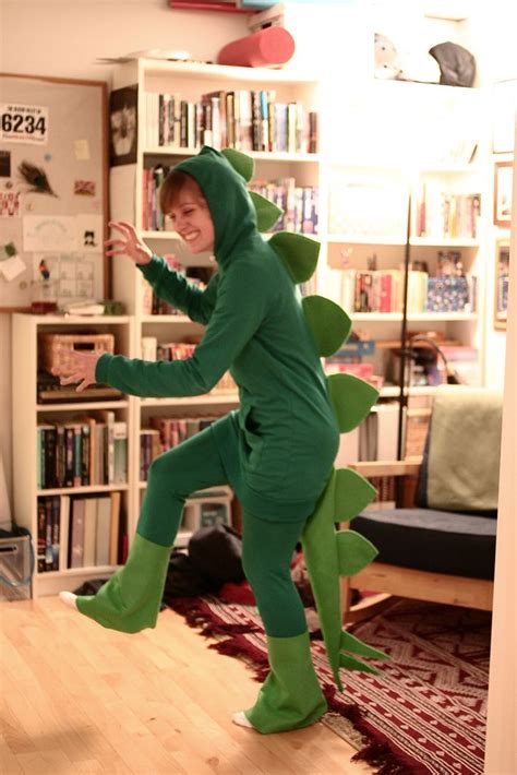 A Person In A Green Dinosaur Costume Dancing