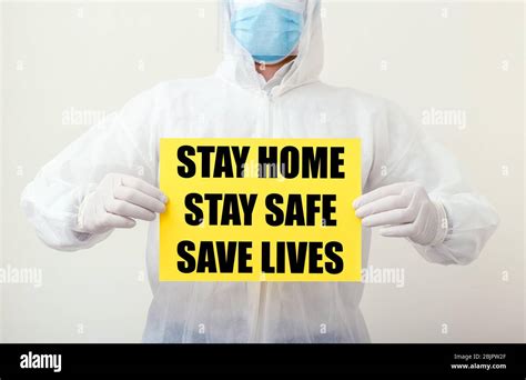 Stay Home Stay Safe Save Lives Text On Yellow Warning Sign In Doctors
