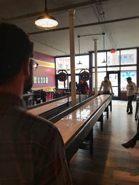 Shuffleboard is a simple but addictive game that involves sliding metal weights (also known as pucks or quoits) down a smooth wooden table to a scoring area at the opposite end. Shuffleboard Rules | How to Play Shuffleboard: A Complete ...