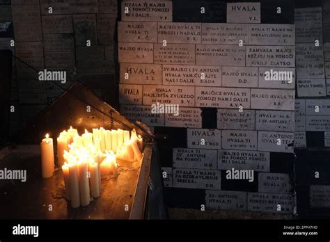 Lighting candles in chapel of Our Lady from the Kamenita vrata (Stone