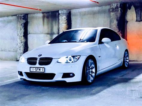 A White Car Parked In A Parking Garage