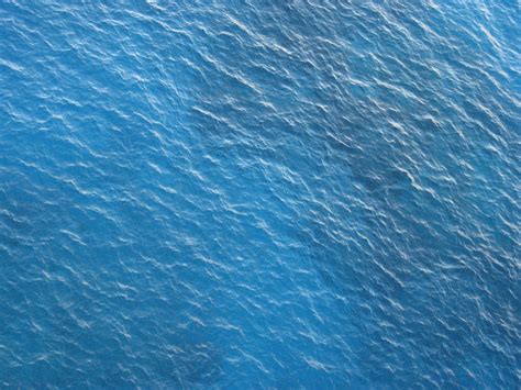 The texture has very soft blue water ripples with sun. Texture water, Sea texture, Water background