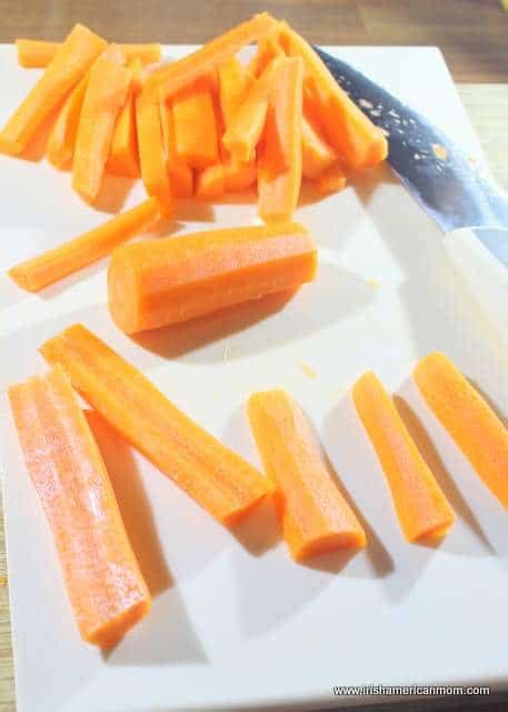 To julienne a carrot, first cut ends off the carrot and peel. On the side | Irish American Mom