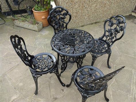 Photo about old fashioned gold colored cast iron table and eight chairs on formal lawn. CAST IRON GARDEN / PATIO SET - TABLE AND 4 CHAIRS -- | in ...