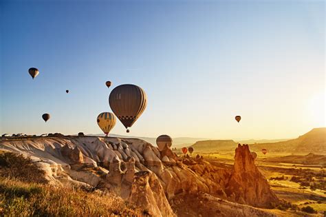 Hot Air Balloons Flying At Sunset Cappadocia Turkey Stock Photo