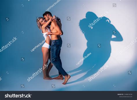 shirtless man hugging kissing woman shadows stockfoto 1248818104 shutterstock