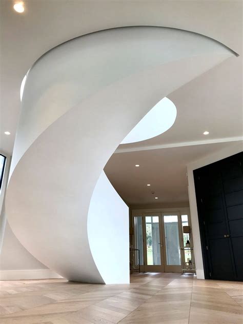 Curved concrete stairs and landing - Shuttered, steel fixed and poured - Cladded with European ...