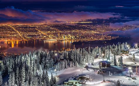 City Lights From The Snowy Peak Of Grouse Mountain At Twilight