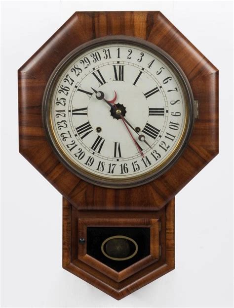 An Antique American Wall Clock In Walnut Case Eight Day Time Clocks