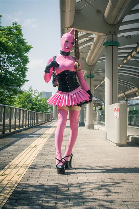 Pink Latex Rubber Clothing With Black Randoseru In Public A Photo On