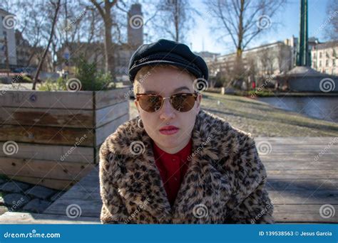 Girl With Shaved Blond Hair And With Alternative Outfit And Sunglasses