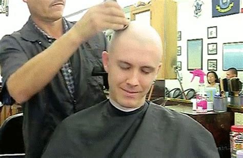 A Barber Boy Enjoying Being Caped And In The Chair Balding Shaved