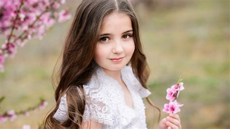 Little Cute Girl Is Having Pink Flowers In Hand Wearing White Dress Hd