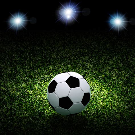 Soccer Ball On Grass Against Black Background Royalty Free Stock Image
