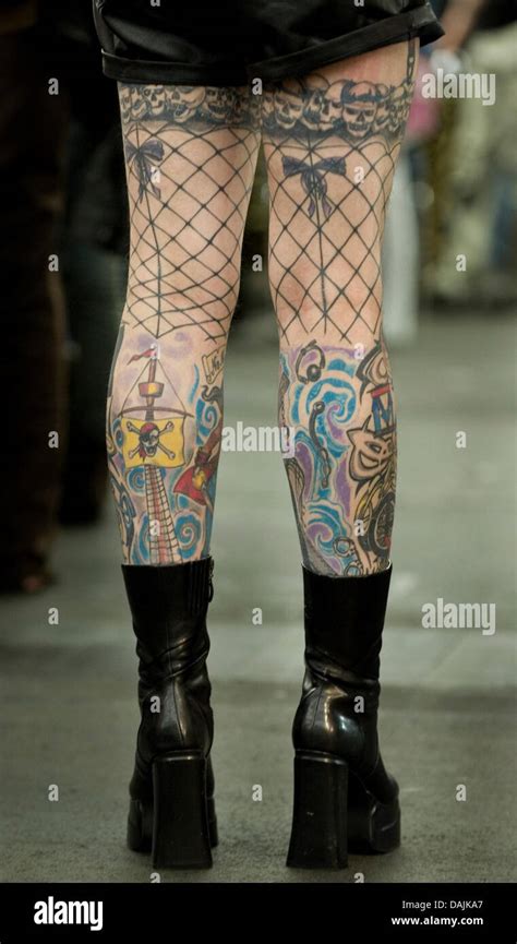 a tattoo fan has net stockings tattooed on his legs at the 19th international tattoo convention