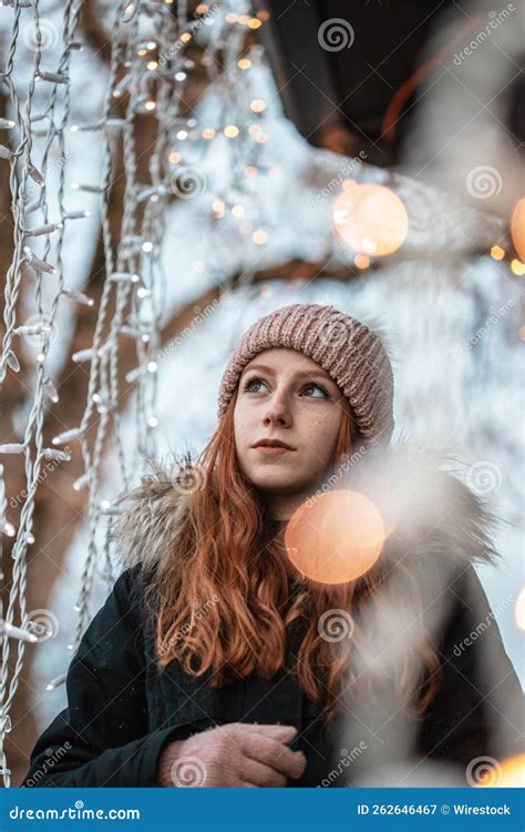 Portrait Of A Redhead Young Girl Surrounded By Christmas Lights Outside