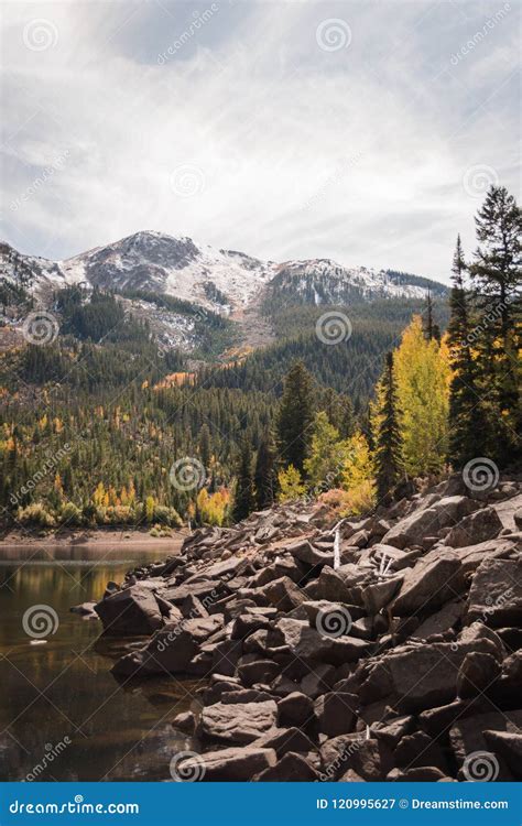 Landscape View Of A Lake Snow Capped Mountains And Fall Foliage Near