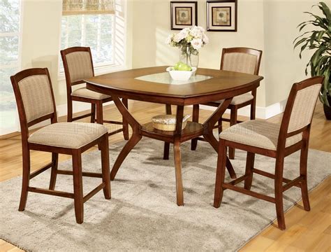 Buying the right table to fit your needs can save you the annoyance of accumulating scratches, dents, chips and other damages. CM3026PT Redding II 5Pc Counter Height Dining Set in Oak