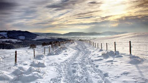 Snow Covered Road Under Beautiful Clouds Wallpapers And Images