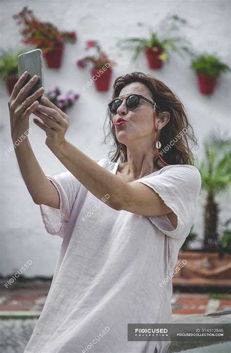 Trendy Outgoing Woman In Sunglasses Taking Selfie On Mobile Phone On Marbella Street