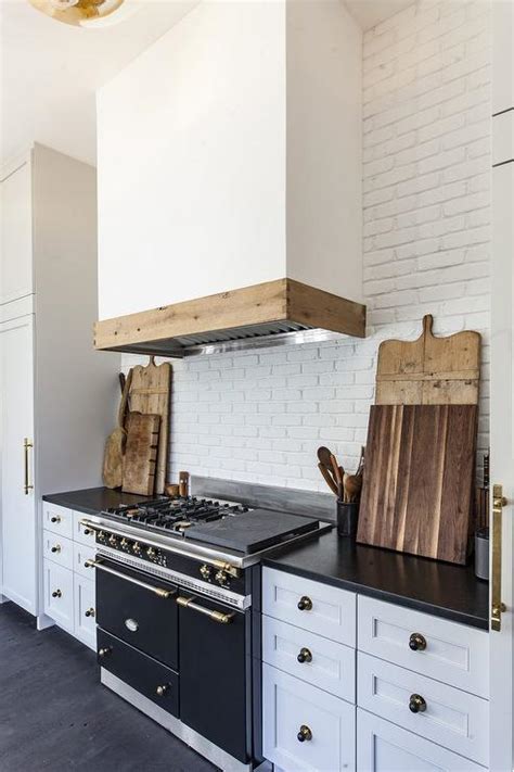 White And Black Kitchen With Exposed White Brick Wall