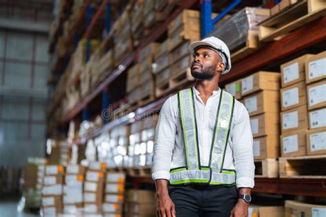 African Warehouse Manager Standing In A Large Distribution Center