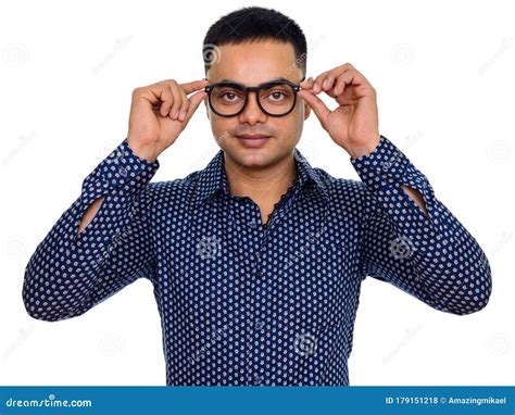 Studio Shot Of Young Handsome Indian Man With Glasses Isolated Against