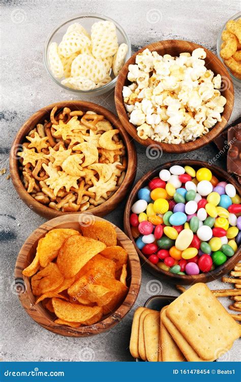 Salty Snacks Pretzels Chips Crackers In Wooden Bowls And Candy And