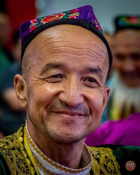 An elderly Uyghur gentleman wearing traditional clothing dances in the ...