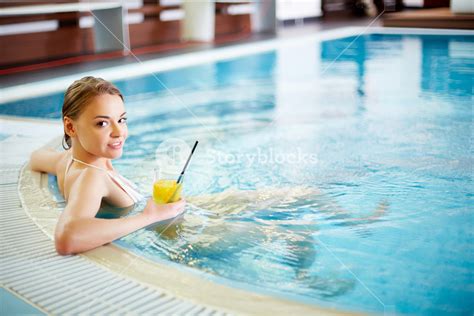 Pretty Girl Relaxing In Swimming Pool Royalty Free Stock Image